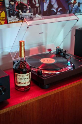 a bottle of wine sitting next to a record player at W Montreal in Montréal