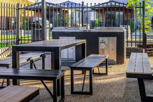 a group of picnic tables in front of a building at BIG4 Albury Tourist Park in Albury