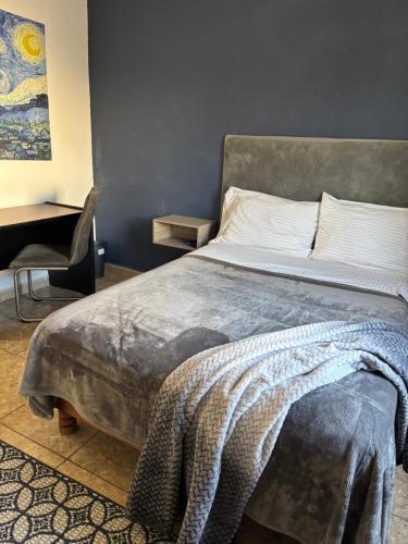 a bedroom with a bed with a blanket on it at Habitacion Arboleda in Saltillo