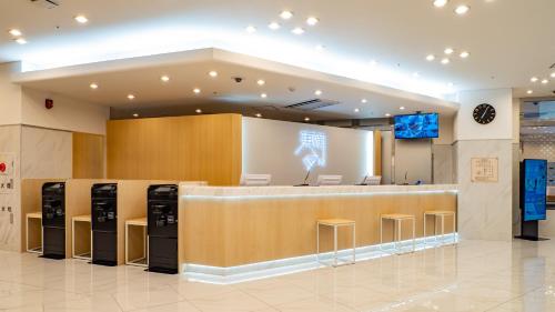 a lobby of a store with a counter and stools at Toyoko Inn Nagasaki Ekimae in Nagasaki