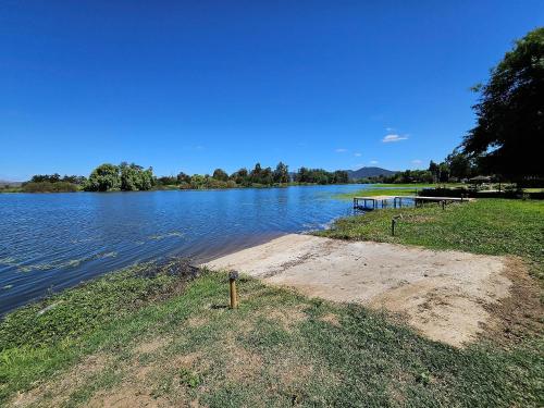 a large body of water with a boat dock at Acogedora Casa Frente al Lago Rapel in Las Cabras