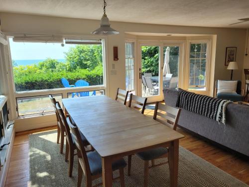 a dining room with a wooden table and chairs at Great Lakes Getaway - Incredible Lakefront! in Frankfort