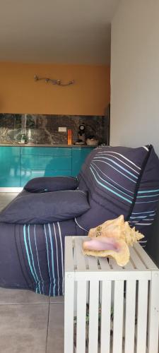 a bedroom with a bed and a white crib at Le Triton in Deshaies