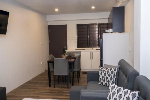 a kitchen and living room with a couch and a table at Garden Apartments in Nadi