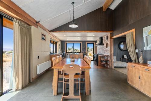 a kitchen and dining room with a wooden table and chairs at A Place in Thyme - Alexandra Holiday Home in Alexandra
