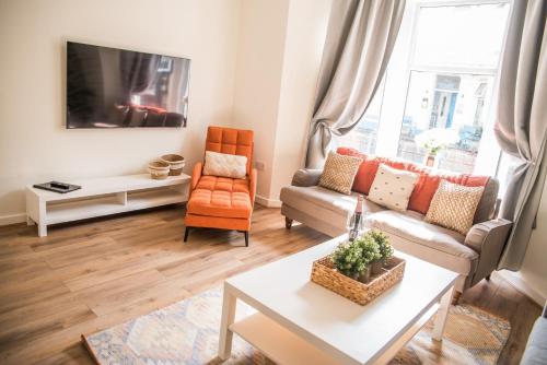 a living room with a couch and a table at Vance Retreat in Blackpool
