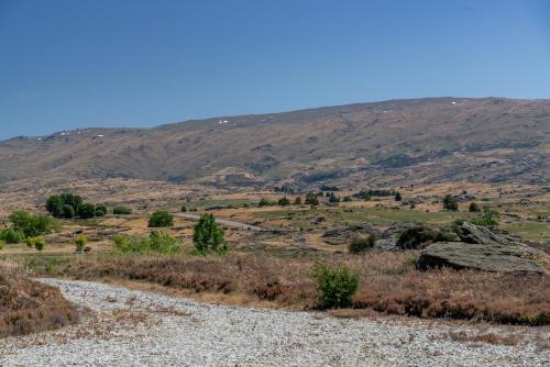 a view of a mountain from a gravel road at A Place in Thyme - Alexandra Holiday Home in Alexandra