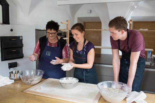 a group of people in a kitchen preparing food at Exclusive Apartment Tassenbacherhof in Strassen