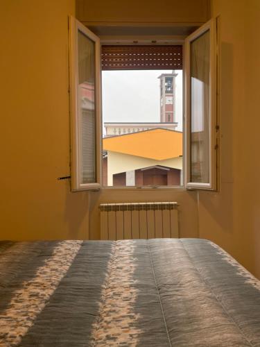 an open window with a view of a building at Appartamento nuovo e moderno in Cesano Maderno