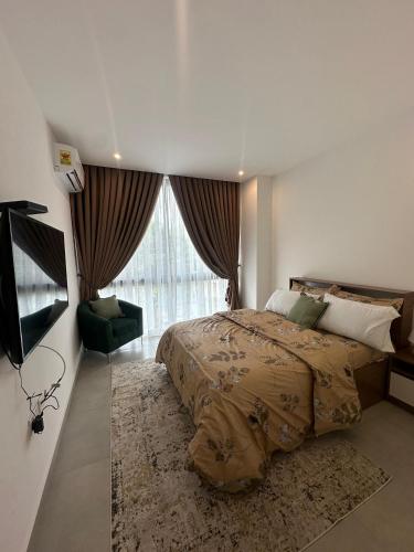 a bedroom with a bed and a large window at Luxury Nova Roman Ridge 2-bedroom apartment in Accra - FiveHills homes in Accra