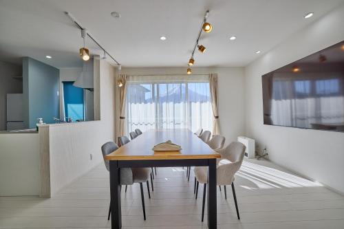 a dining room with a wooden table and chairs at MIYA HOUSE Funatsu A in Fujikawaguchiko
