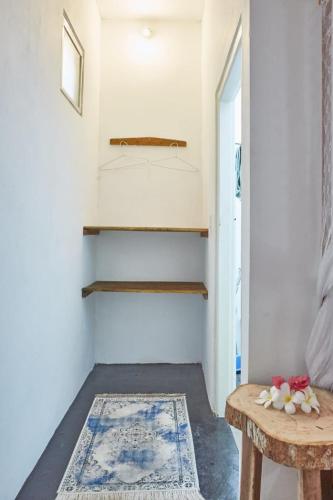 a hallway with a table and a rug at Surf &Turf Arugam Bay in Arugam Bay