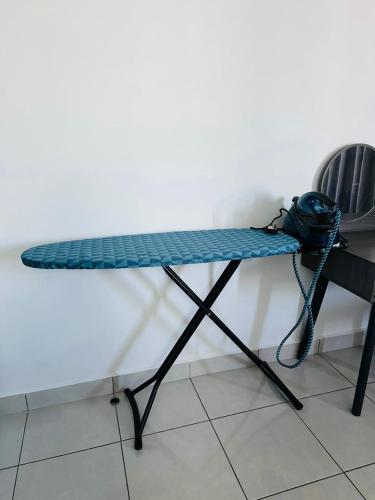 a table with a backpack on it next to a chair at B3A-5 Suites in Papar