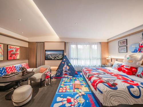 a bedroom with a large bed with a christmas themed bedspread at Homm Changchun Beihu in Changchun