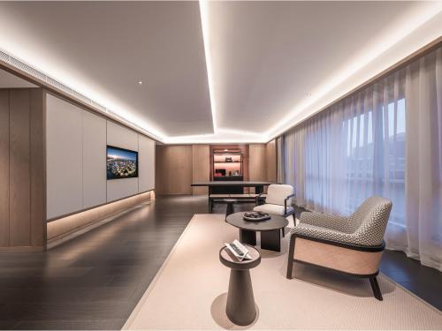 a living room with a couch and a table at Homm Changchun Beihu in Changchun