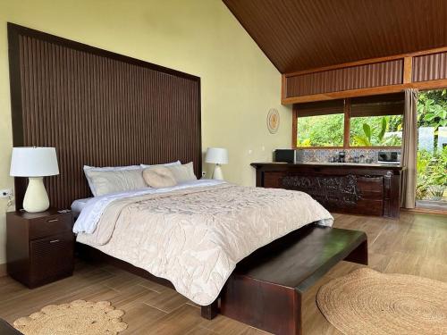 a bedroom with a large bed and a window at Ara Ambigua Lodge in Sarapiquí