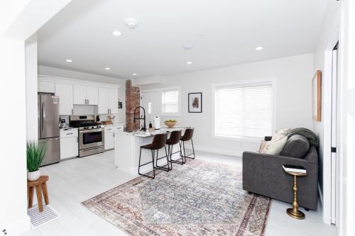 a living room with a couch and a kitchen at Adjoining Condominium Units Sleeps 12 in Downtown Sandusky! in Sandusky