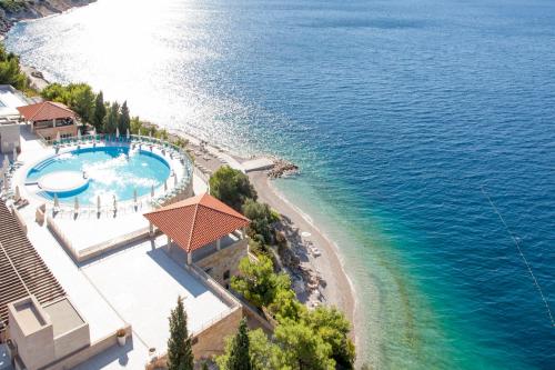 an aerial view of a resort with a swimming pool and a beach at Sun Gardens Dubrovnik in Dubrovnik