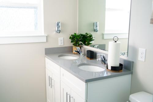 a bathroom with two sinks and a mirror at Hidden Gem 2 in Norristown