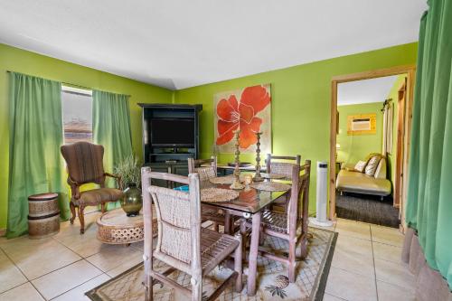 a living room with a dining room table and chairs at Blue Bell Apartment Hotel in Fort Lauderdale