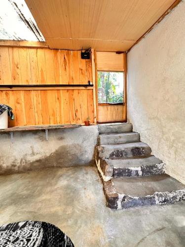 an empty room with stairs in a house at Cabaña del Ciprés interior in San Pedro La Laguna