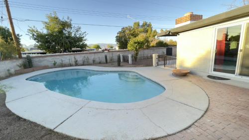 a swimming pool in the backyard of a house at Private Home - Heated Pool, Billiards, Darts, Foosball, Fireplace, 5 Smart TVs, BBQ, Cotton Bedding - The Saguaro Sanctuary, Pool Heat Optional in Tucson