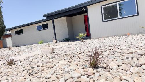 a house with a large pile of rocks in front of it at Private Home - Heated Pool, Billiards, Darts, Foosball, Fireplace, 5 Smart TVs, BBQ, Cotton Bedding - The Saguaro Sanctuary, Pool Heat Optional in Tucson