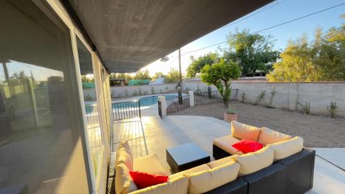 a living room with a couch on a patio at Private Home - Heated Pool, Billiards, Darts, Foosball, Fireplace, 5 Smart TVs, BBQ, Cotton Bedding - The Saguaro Sanctuary, Pool Heat Optional in Tucson