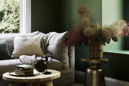 a vase on a table next to a couch at The Church at Lyonville - Daylesford Region in Lyonville
