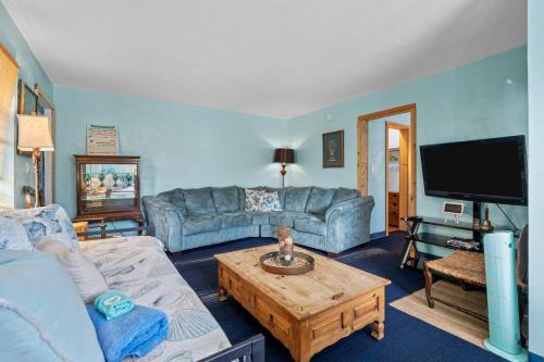 a living room with a couch and a table at Blue Bell Apartment Hotel in Fort Lauderdale