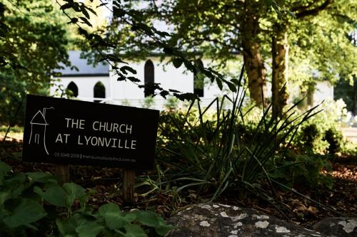 a sign in front of a church at a cemetery at The Church at Lyonville - Daylesford Region in Lyonville