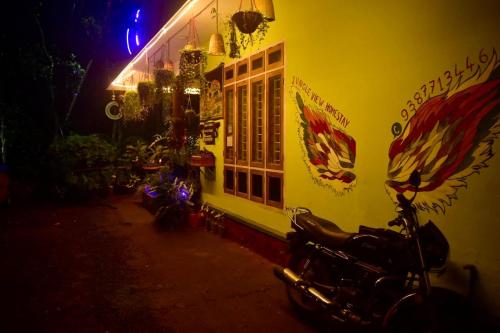 a motorcycle parked in front of a building at night at Jungleview Home Stay in Idukki