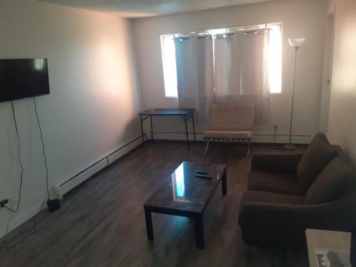 a living room with a couch and a coffee table at Victoria Trail Apartments in Edmonton