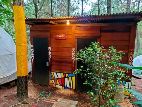 a dog house in the middle of a forest at vanderman land camp in Batu