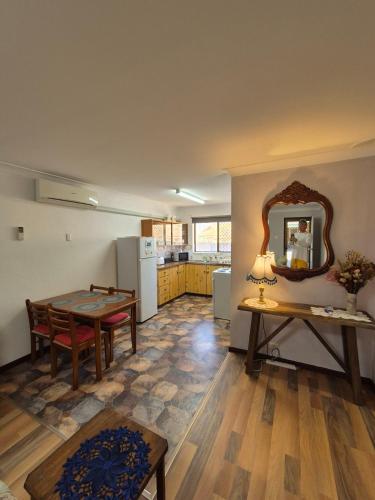 a living room with a table and a mirror at Champion Bay Beach Unit, with own carport, in Geraldton