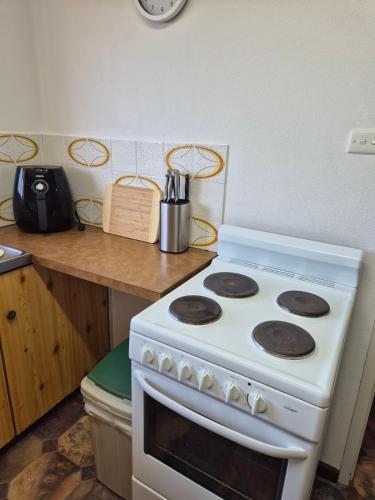 a white stove in a kitchen with a counter at Champion Bay Beach Unit, with own carport, in Geraldton