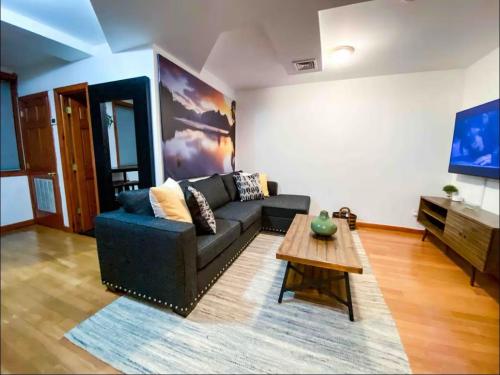 a living room with a couch and a coffee table at La Quinta Loft in Long Island City