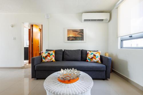 a living room with a couch and a table at Avila Suites in San Juan