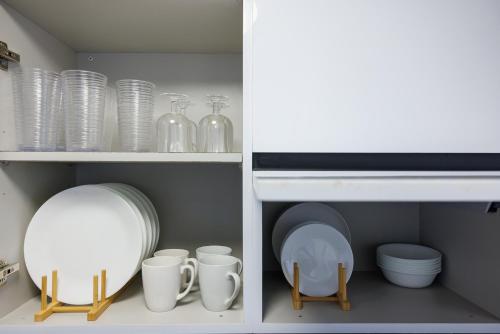 a cupboard with dishes and plates and a mirror at Avila Suites in San Juan