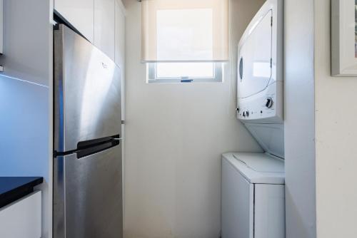 a small kitchen with a sink and a refrigerator at Avila Suites in San Juan