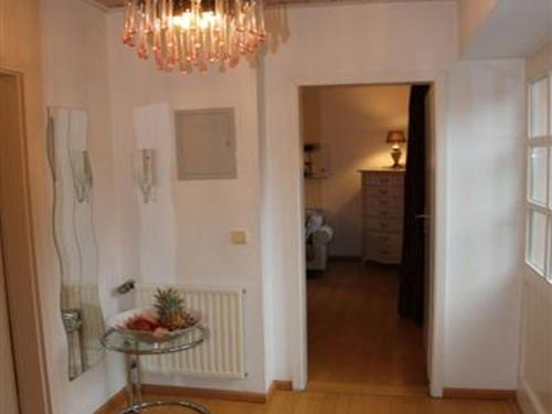 a hallway with a chandelier and a table in a room at Romantikappartements Staufen in Staufen im Breisgau