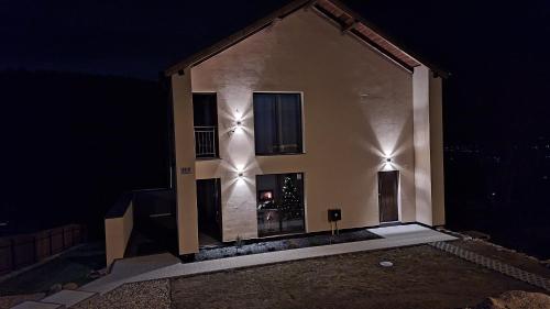 a house with lights on the side of it at night at Skalnica in Karpacz