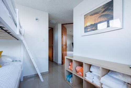 a room with a bed and a staircase with towels at Avila Suites in San Juan