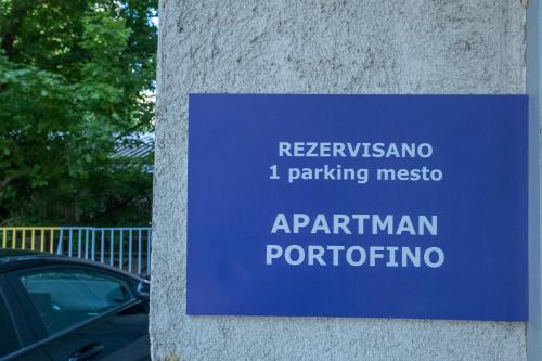 a blue sign on the side of a wall at PORTOFINO, With Free Private GARAGE in Novi Sad