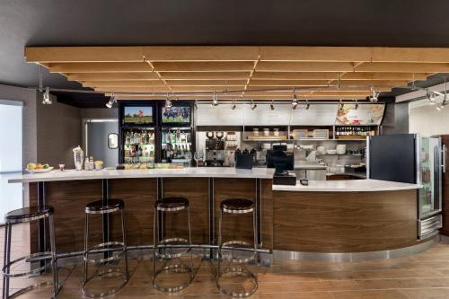 a kitchen with a bar with stools around it at Courtyard Lubbock in Lubbock