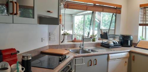 a kitchen with a sink and a counter top at Beautiful room for you in Auckland