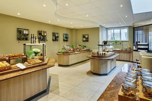 a restaurant with a bunch of counters with food at Courtyard by Marriott Schwerin in Schwerin