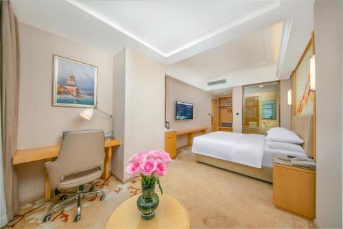 Voodi või voodid majutusasutuse Vienna Hotel Xi'an Hancheng Lake Old City toas