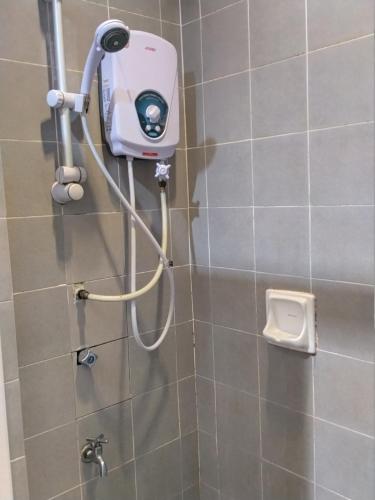 a shower with a hair dryer in a bathroom at Akar Beach Resort in Port Dickson