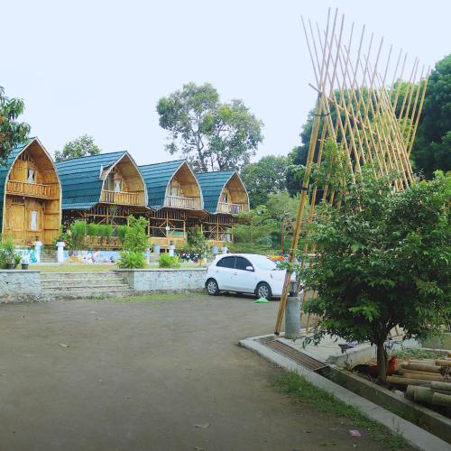 a white car parked in a parking lot in front of a house at Homestay Syariah Tipe C Kadudampit Sukabumi in Citamiang